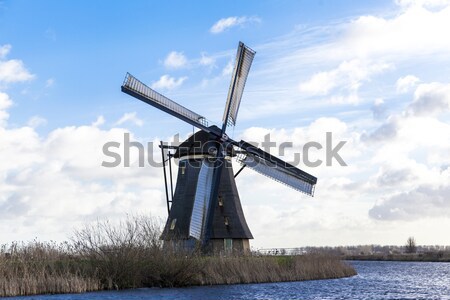 Traditional dutch windmill near the canal. Netherlands. Old windmill stands on the banks of the cana Stock photo © mcherevan
