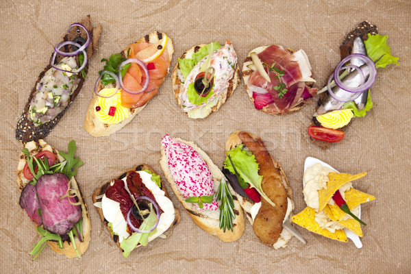 Stock photo: Set of Spanish tapas on the textiles background . Great background for restaurant, cafe