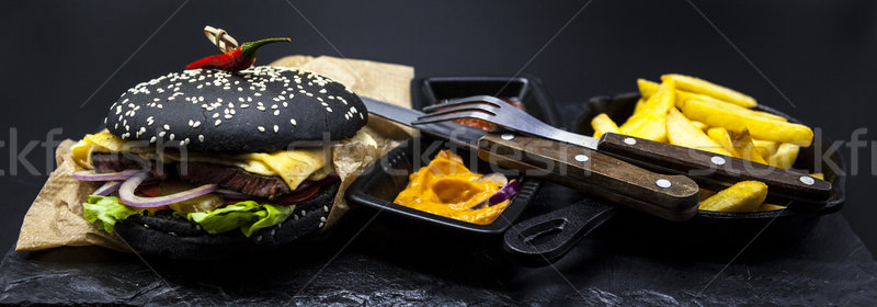 Stock photo: Set of the black burger. Stone plate with: black burger roll slices of juicy marble beef, fused chee