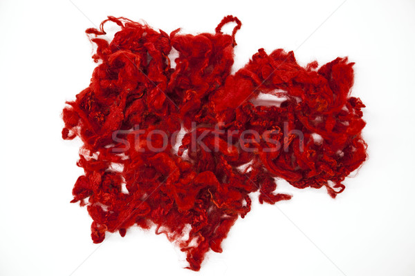Stock photo: Red piece of Australian sheep wool Merinos breed close-up on a white background