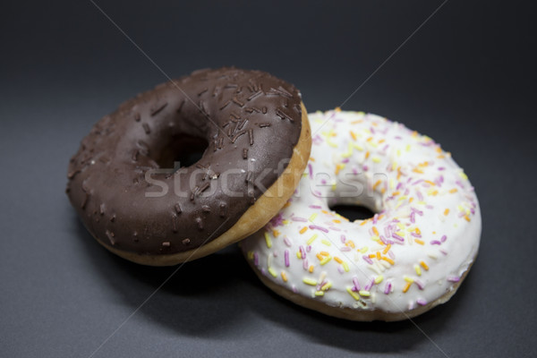 Fresh juicy sweet pastries donuts on a dark background. Stock photo © mcherevan