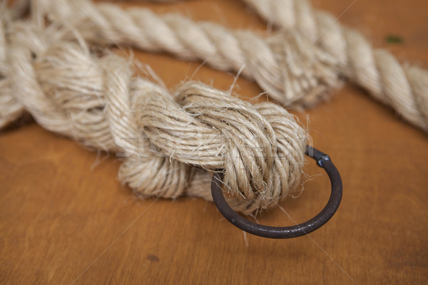 Stock photo: Coil of rope with a marine unit, and an iron ring.