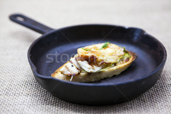 Home baked hot sandwich with chicken cheese, onion, chile pepper, garlic  on a cast-iron pan on a te Stock photo © mcherevan