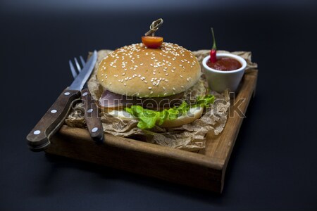 Black burger. A burger with a black roll slices of juicy marble beef, fused cheese, fresh salad and  Stock photo © mcherevan