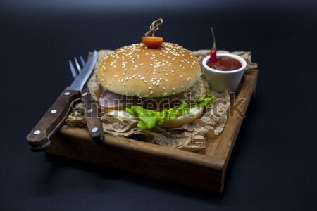 Stock photo: Black burger. A burger with a black roll slices of juicy marble beef, fused cheese, fresh salad and 