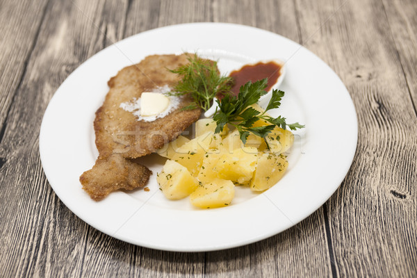 Petite Wiener schnitzel with boiled potatoes and ketchup. Served on a white porcelain plate on a woo Stock photo © mcherevan