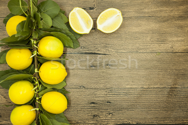 Branch of fresh juicy Sicilian lemons on a wooden background Stock photo © mcherevan