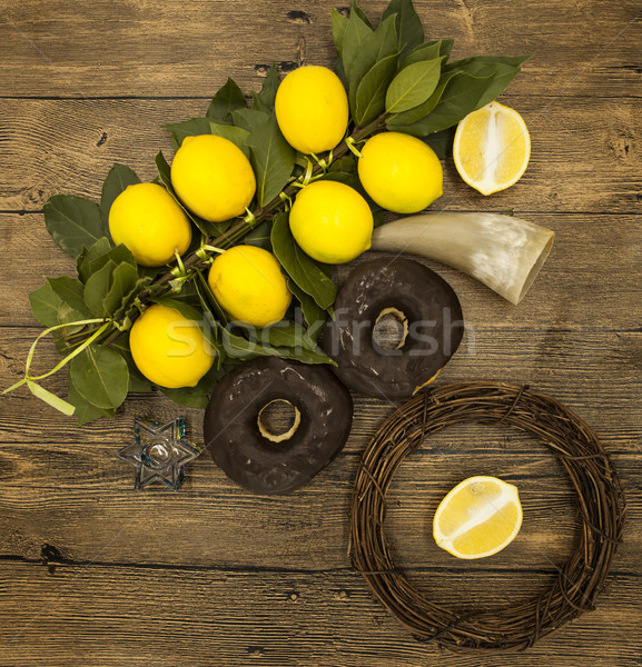  Branch lemons  donuts and goat horn. Symbols of the great holiday of Hanukkah. On wooden background Stock photo © mcherevan