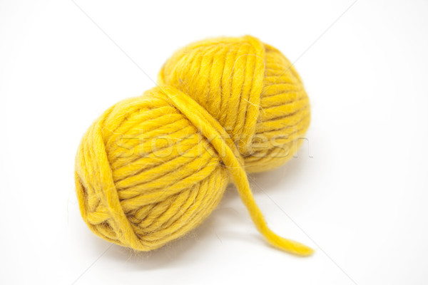 Stock photo: Yellow ball of wool yarn for knitting close up on a white background.