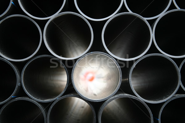 Stock photo: gray pvc pipes stacked in construction site 