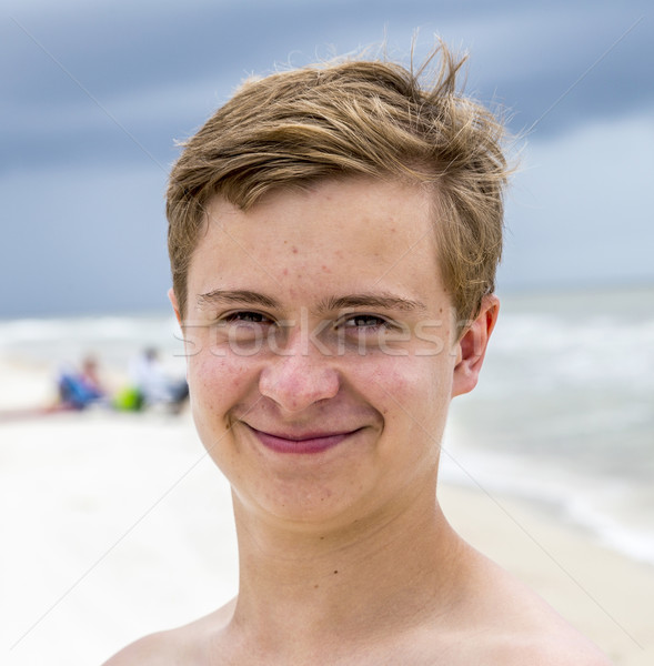 young happy boy looking handsome at the beach Stock photo © meinzahn