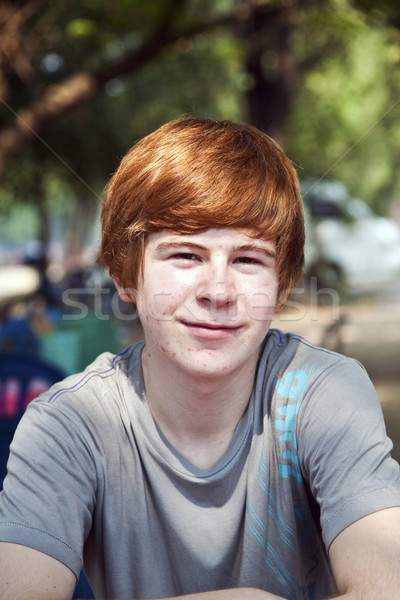 boy with red hair and pickax in the face looks happy  Stock photo © meinzahn