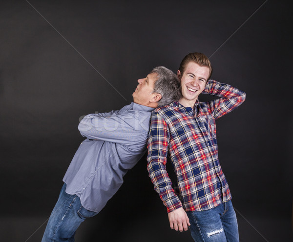 Stock photo: father and son lean on back to back