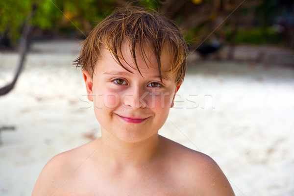 happy boy with wet hair at the beach smiles and looks very self  Stock photo © meinzahn