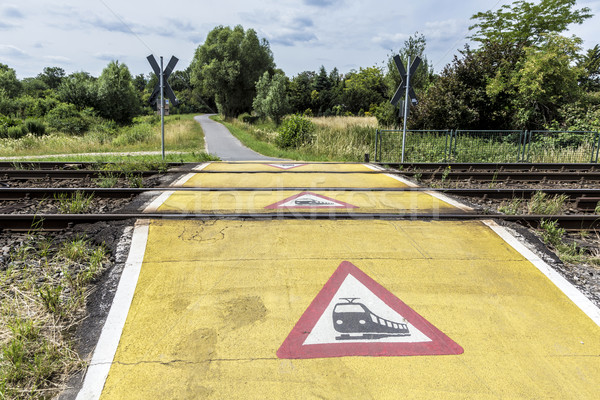 train warning sign at a railroad crossing Stock photo © meinzahn