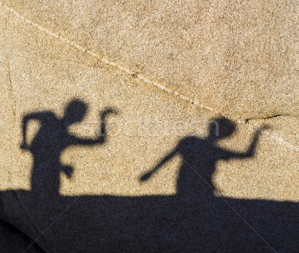 children playing with shadows on a rock Stock photo © meinzahn