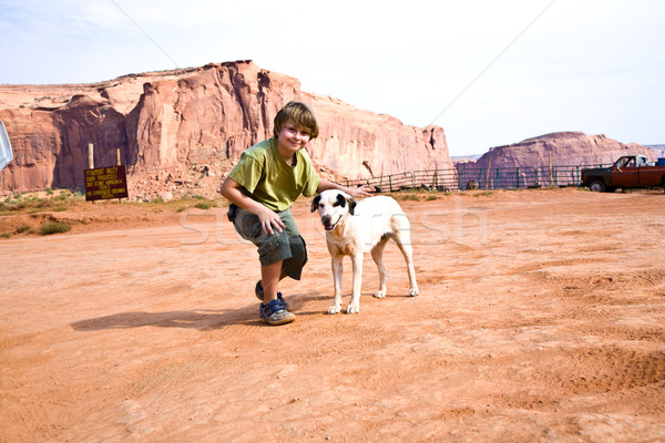 Monument Valley, boy strokes a beautiful lovely dog in the lands Stock photo © meinzahn