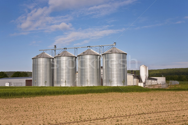 silver shining silo with acre in landscape Stock photo © meinzahn