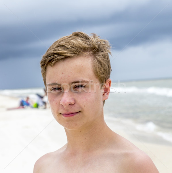 young happy boy looking handsome at the beach Stock photo © meinzahn