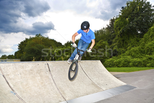 boy has fun with his BMX at the skatepark Stock photo © meinzahn