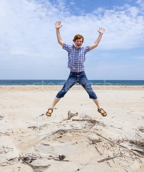 boy enjoys  the beautiful beach and jumps  Stock photo © meinzahn