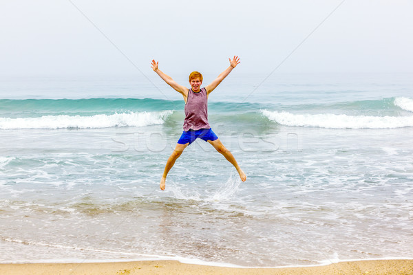 Fiú levegő tengerpart égbolt mosoly boldog Stock fotó © meinzahn