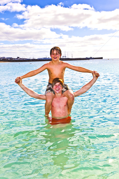 boys having fun in the clear sea  Stock photo © meinzahn