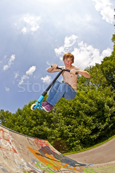 young boy going airborne with a scooter Stock photo © meinzahn