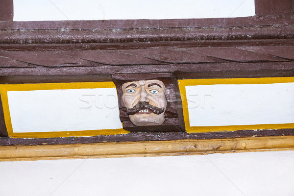 wood carving with funny faces on timber balk  of old framework h Stock photo © meinzahn