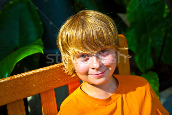 boy relaxing on a bench in the botanical garden Stock photo © meinzahn
