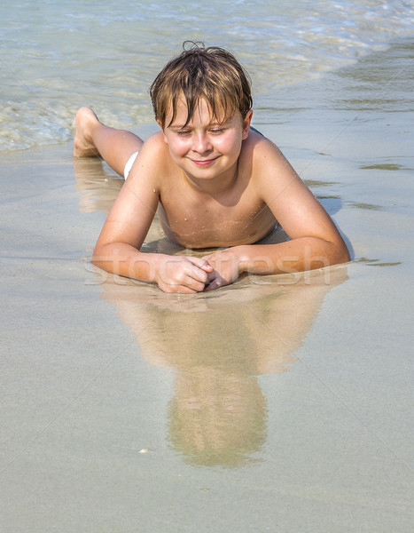 boy at the beach enjoys the sandy beach Stock photo © meinzahn