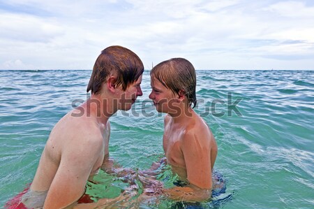 Stock photo: boys having fun in the clear sea 