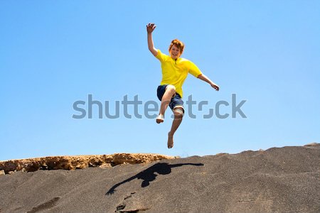 boy has fun jumping in the dunes of the beachin the ocean Stock photo © meinzahn