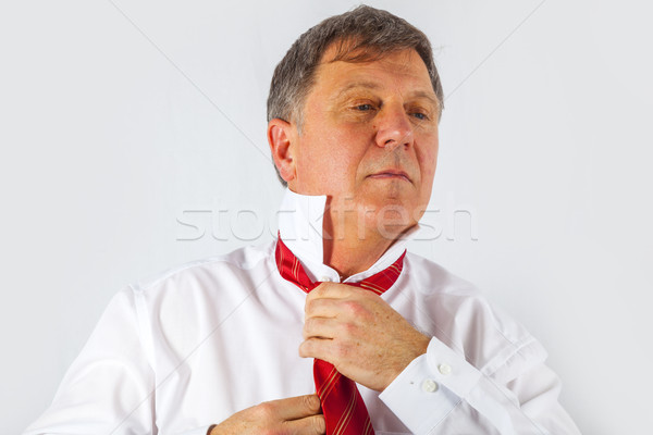 business man binding his tie  Stock photo © meinzahn