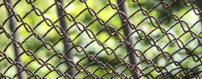 Detail of an old rusting chain fence  Stock photo © meinzahn