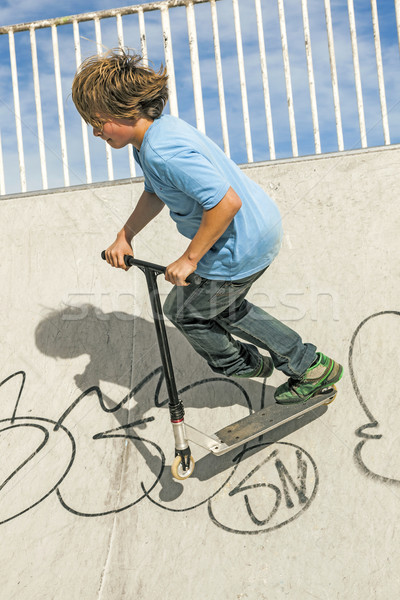 boy with scooter is going airborne  Stock photo © meinzahn