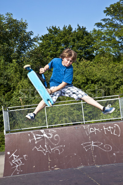 young boy going airborne with a scooter Stock photo © meinzahn