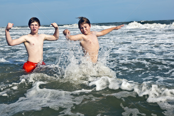 boys enjoying the beautiful ocean and beach Stock photo © meinzahn