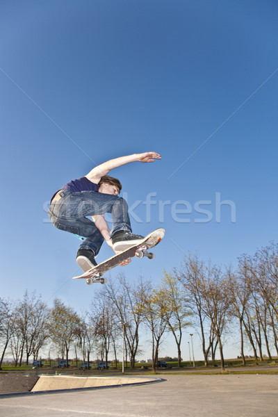 boy with skate board is going airborne  Stock photo © meinzahn
