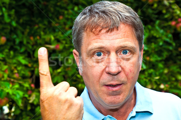 man in garden raises his finger to warn Stock photo © meinzahn