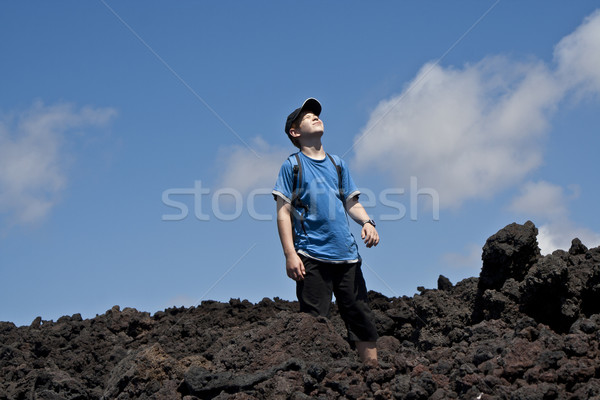 boy on walking trail thru volcanic area Stock photo © meinzahn