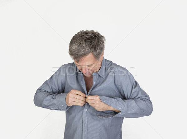 Stock photo: handsome man dressing up with  shirt