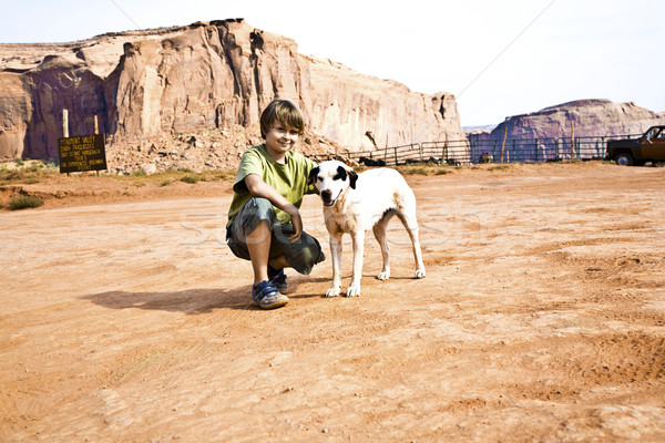 Monument Valley, boy strokes a beautiful lovely dog in the lands Stock photo © meinzahn