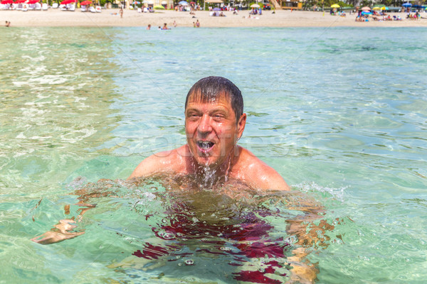 man has fun swimming in the ocean Stock photo © meinzahn