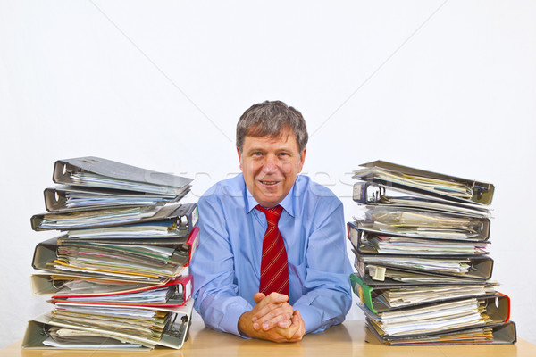 man studies folder with files at his desk in the office Stock photo © meinzahn