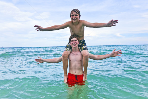 boys having fun in the beautiful clear sea Stock photo © meinzahn