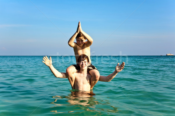 Stock photo: brothers are enjoying the clear warm water at the beautiful beac