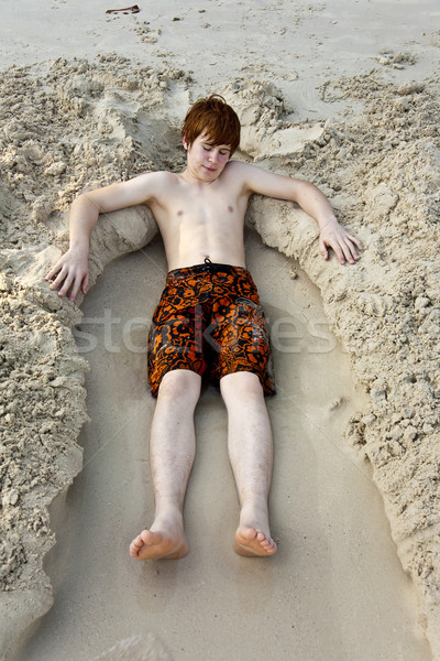 young boy lying at the beautiful beach Stock photo © meinzahn