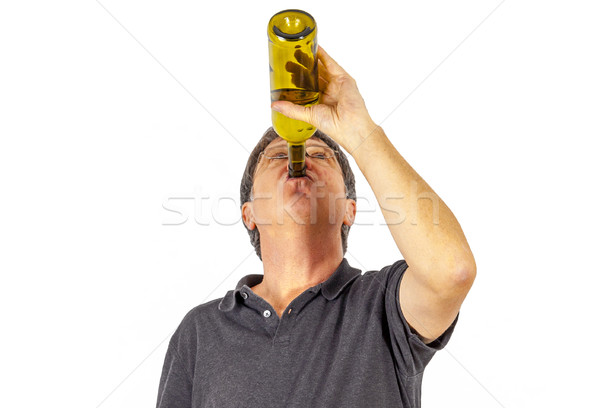 man drinks alcohol out of a bottle Stock photo © meinzahn