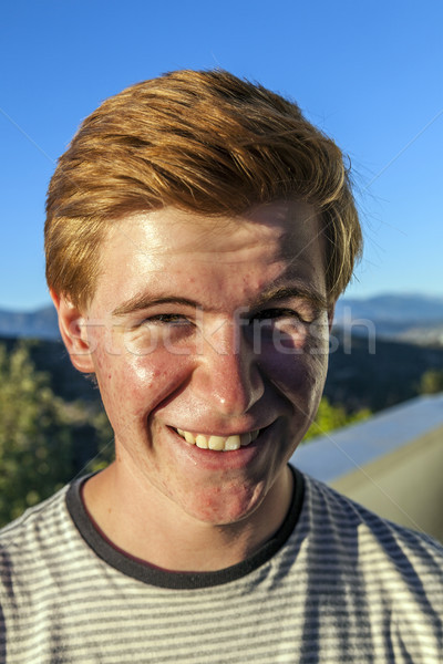 portrait of handsome boy with red hair under blue sky Stock photo © meinzahn